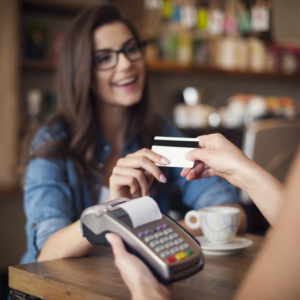 woman handing over credit card